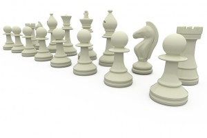 White chess pieces in a row on white background