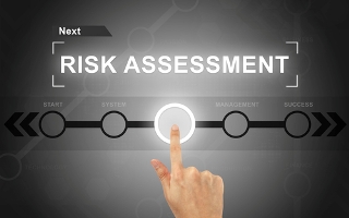hand clicking risk assessment button on a screen interface